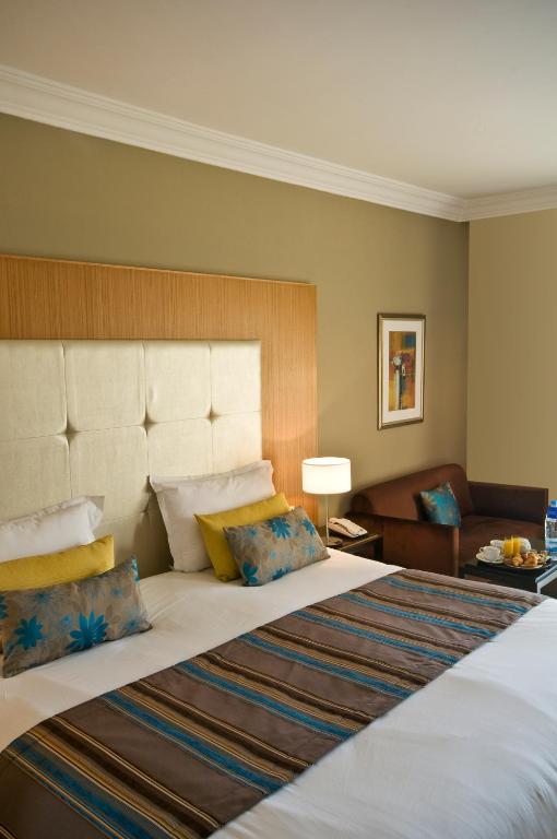 a bedroom with a large bed and a couch at Royal Thalassa Monastir in Monastir