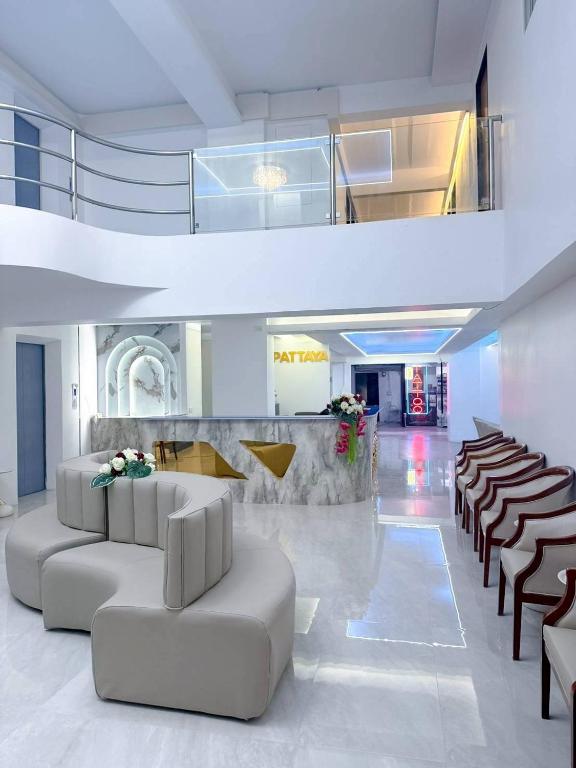 a lobby with couches and chairs in a building at say hi pattaya hotel in Pattaya
