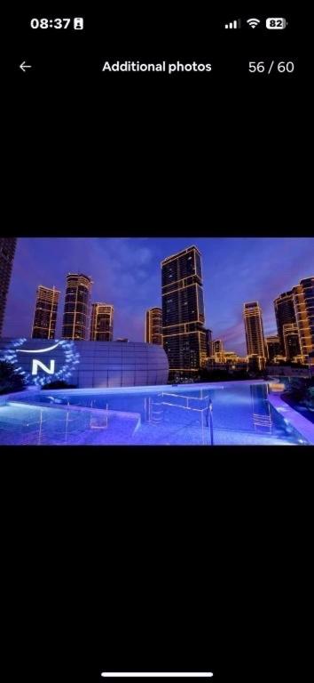 a screenshot of a picture of a city at night at Novotel Rockwell View Hotel Residences in Manila