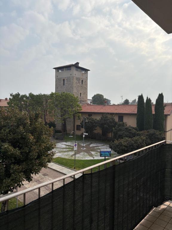 a large building with a fence in front of it at Apartament Orio 3 in Orio al Serio