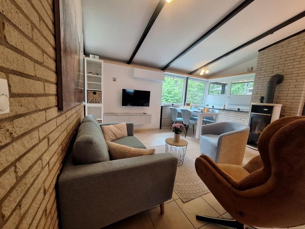 a living room with a couch and chairs at Ferienhaus "WaldLust" - Waldrandlage - Haustierfreundlich in Gerolstein