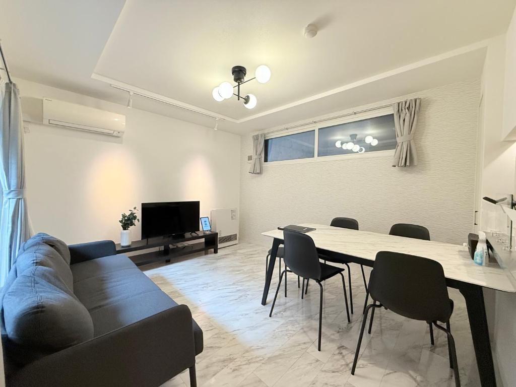 a living room with a couch and a table at GaiarS8 in Sapporo