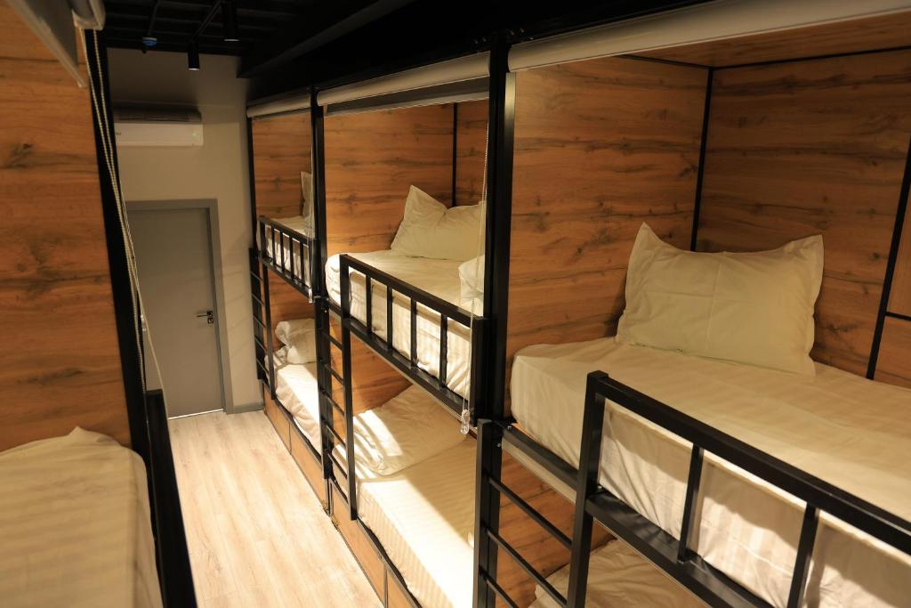 two bunk beds in a room with wooden walls at Doo Hostel Tashkent city in Tashkent
