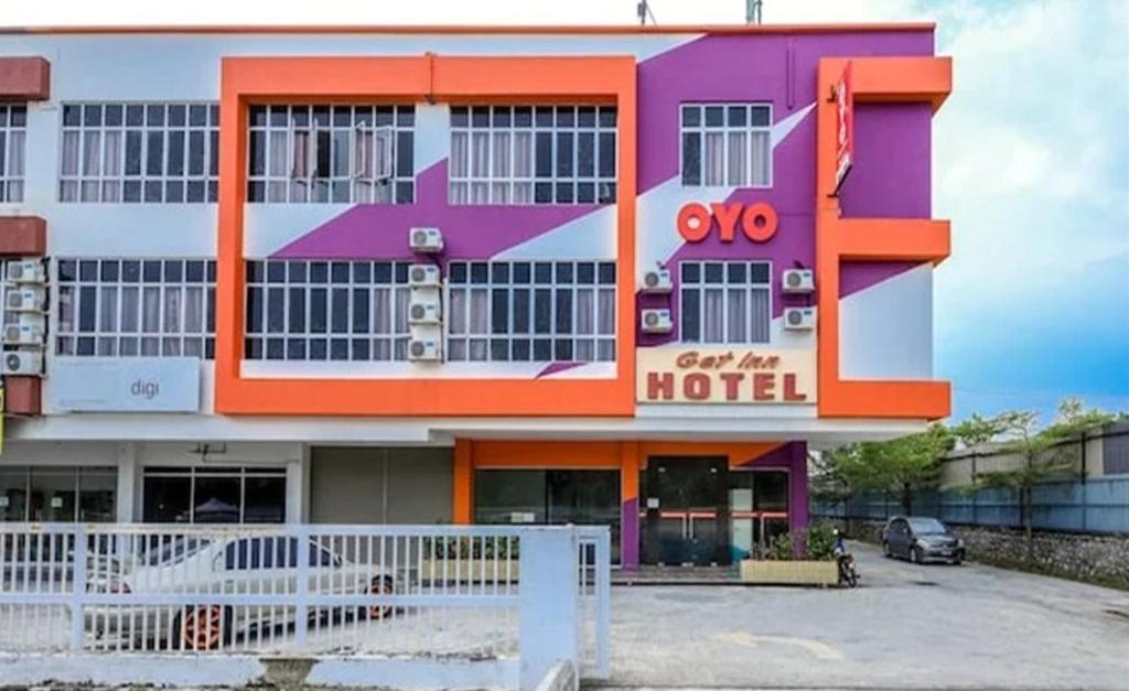 a building with an orange and purple at Get Inn Hotel in Gua Sai