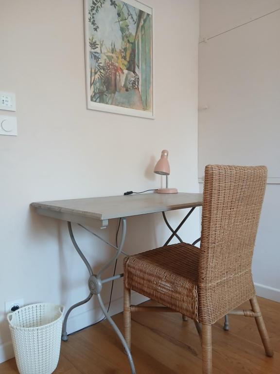 a desk with a chair and a table with a lamp at Appartement à 15 minutes de Hyères et ses plages in Solliès-Ville