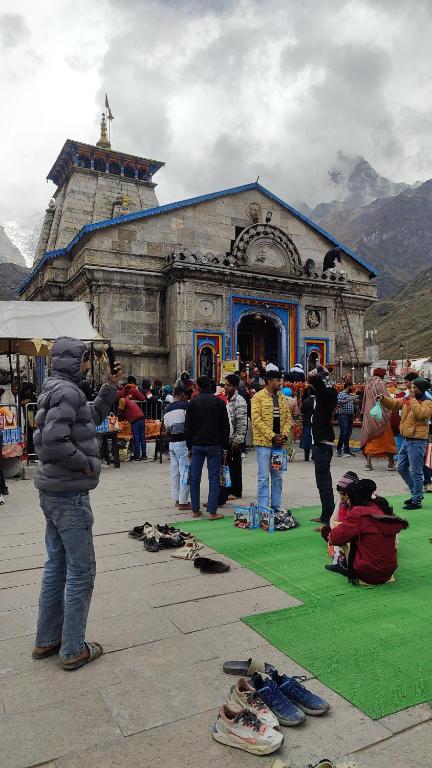 a group of people standing in front of a building at Explore bharat in Kedārnāth