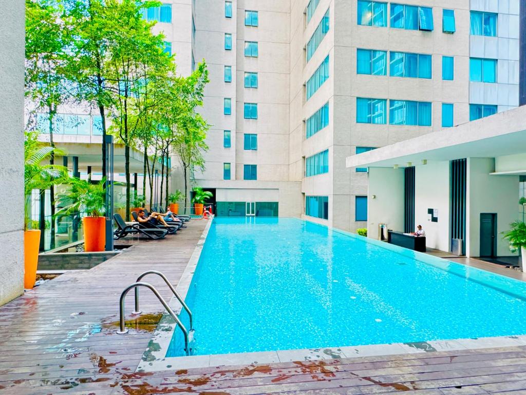 a swimming pool in front of a building at Luxury Mercu Summer Suites KLCC By JT in Kuala Lumpur