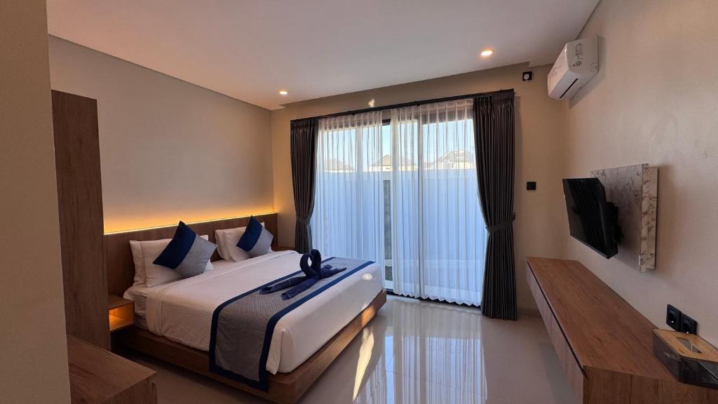 Katil atau katil-katil dalam bilik di Tutur Bali Guest House