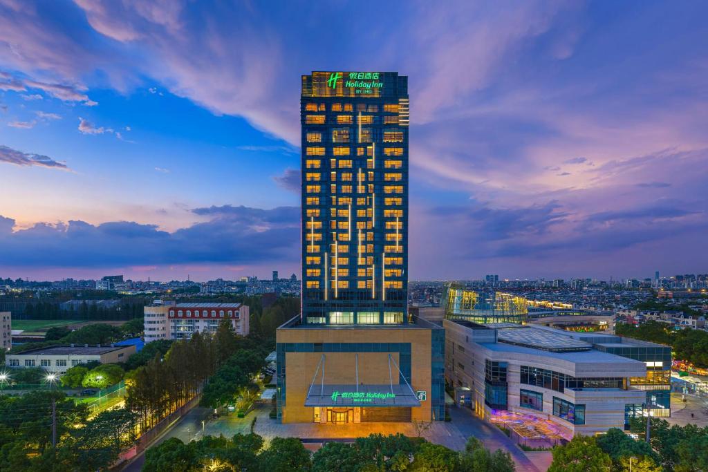 a tall building with lights on top of it at Holiday Inn Shanghai Minhang Center by IHG in Shanghai