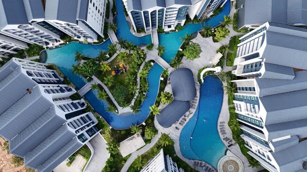 an aerial view of a pool in the middle of a city at Modern 1 & 2 Bedroom Apartments Naiyang Phuket by Mango Family in Nai Yang Beach