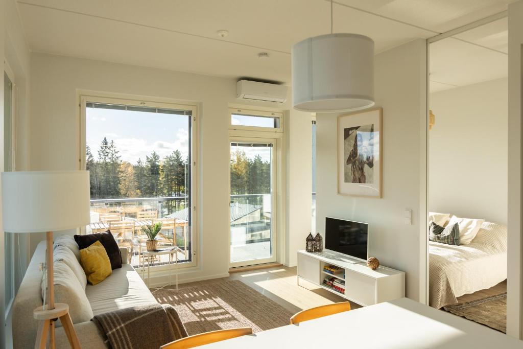 a living room with a couch and a fireplace at Sarvvik Golf and Lakeside Apartment in Sarvvik