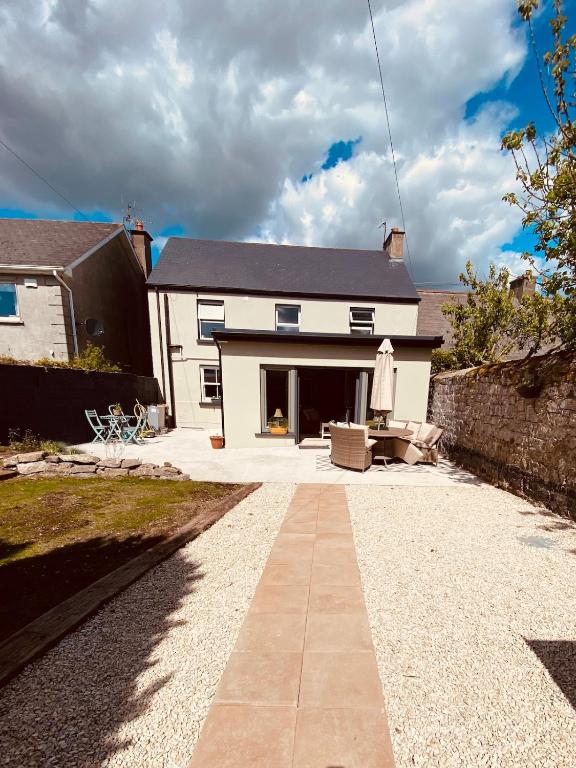 a house with a stone walkway in front of it at Cashel town house 4 bed in Cashel