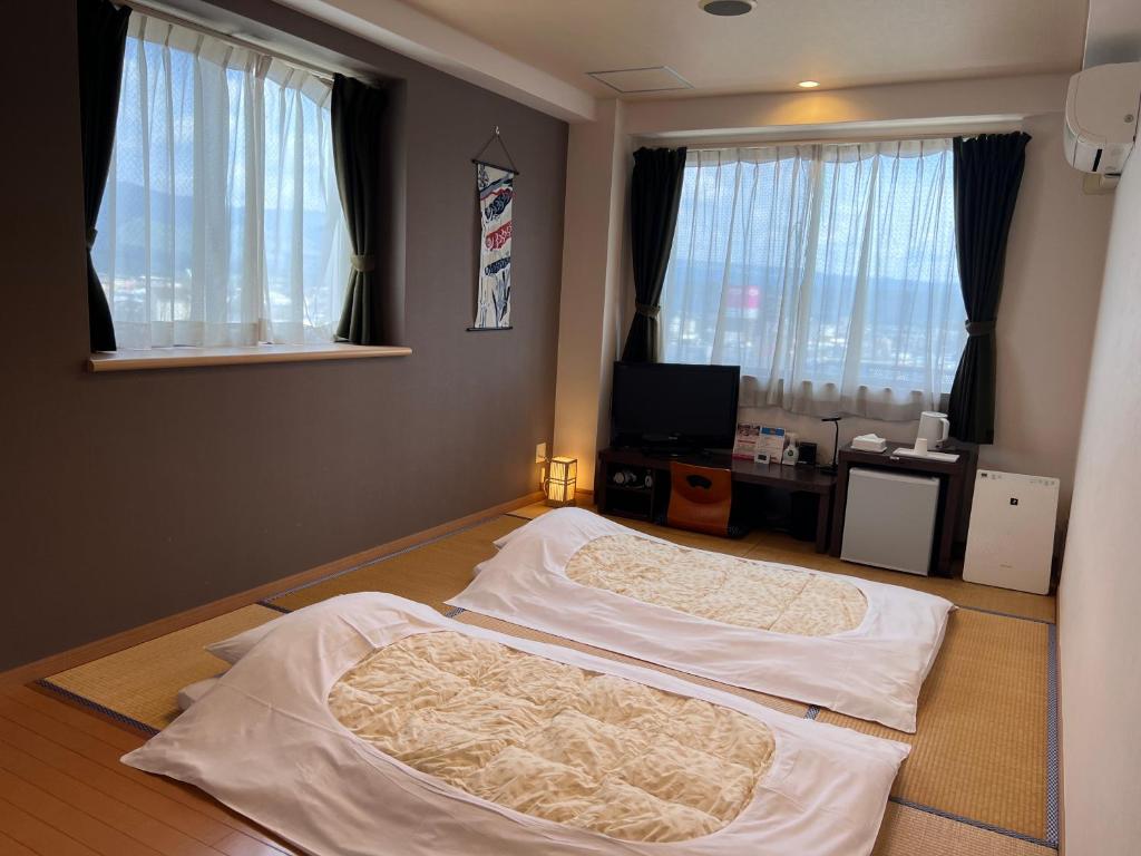 Postel nebo postele na pokoji v ubytování DOMO Hotel 大津