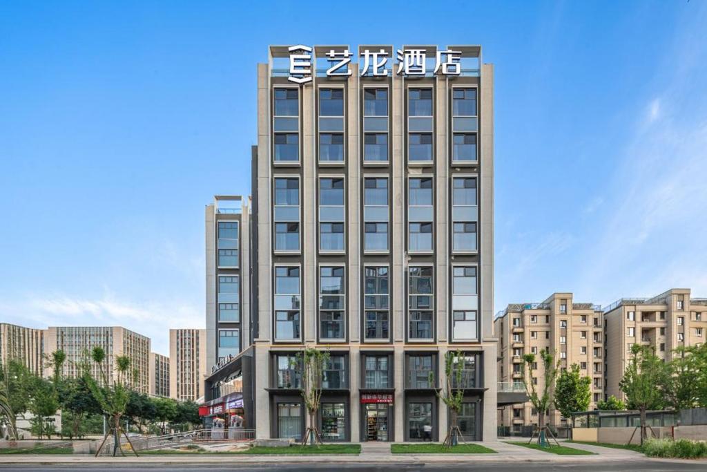 a tall building with a sign on top of it at Elong Hotel Beijing Chang'an Tianjie Bridge Huiying Metro Station Branch in Beijing