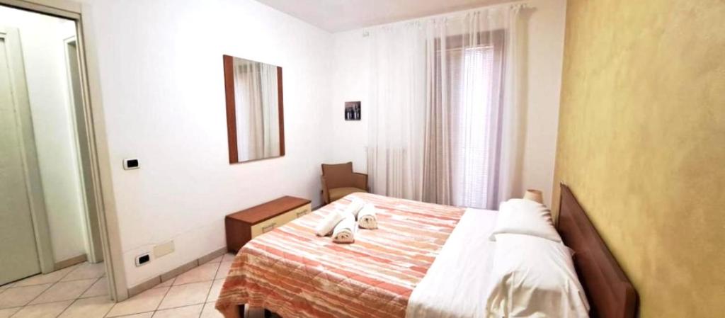 a bedroom with a bed and a mirror at Eli's House in Bardolino sul Garda in Bardolino