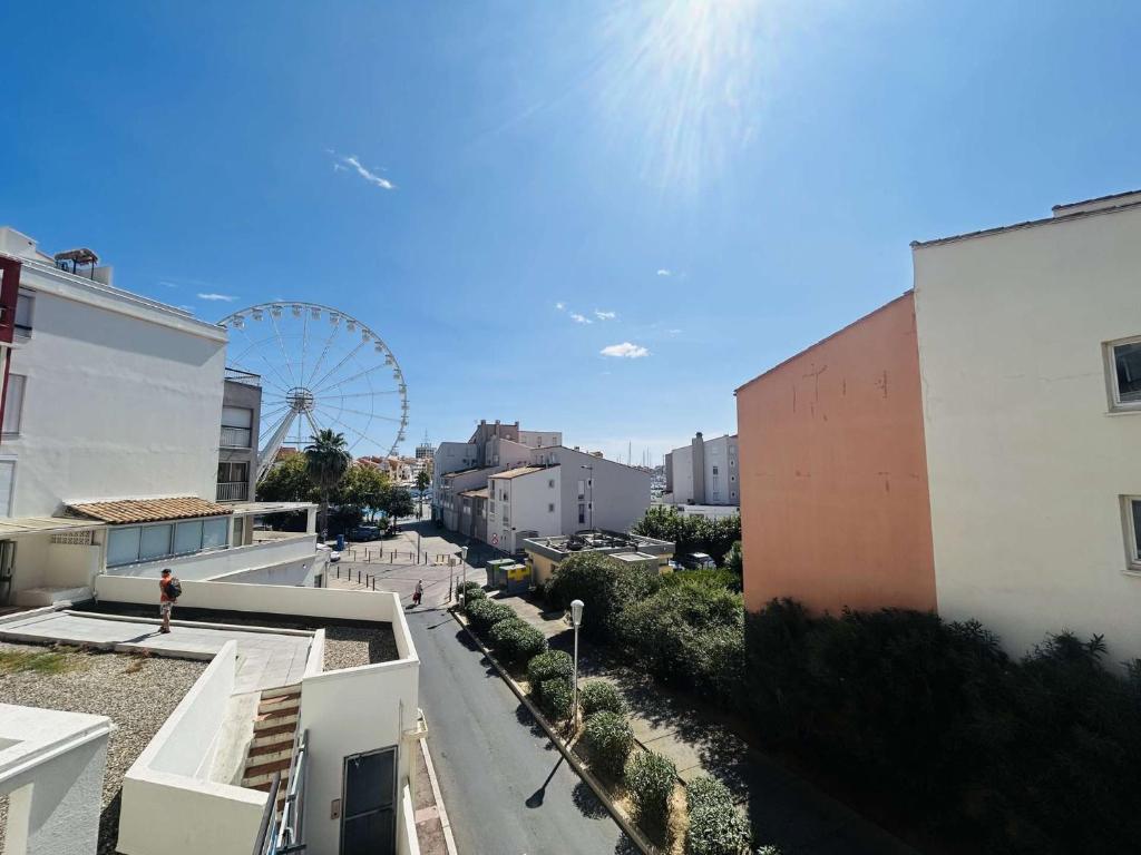 a view of a city with a ferris wheel at Appt Studio 2 couchages CAP D'AGDE CT121-022 in Cap d'Agde