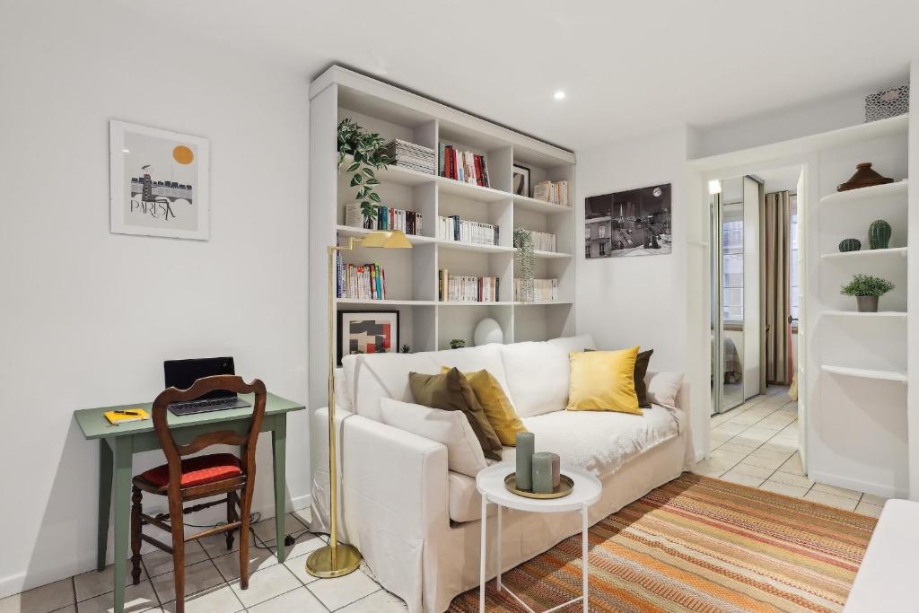 a living room with a white couch and a table at BnBNova - 1BR - Les Invalides & Eiffel Tower in Paris