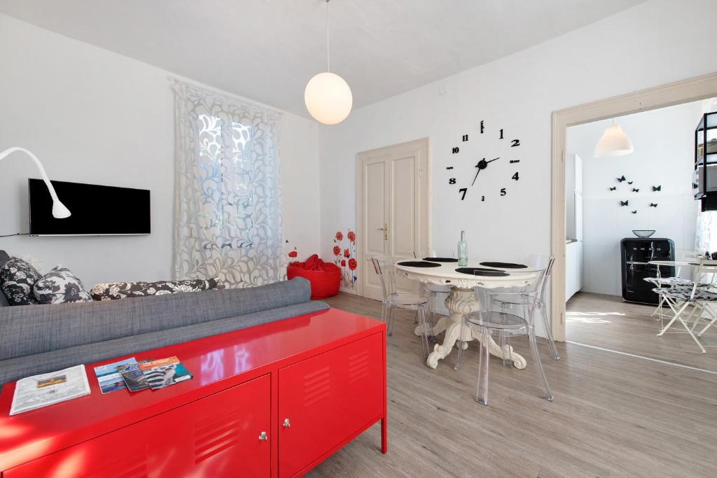 a living room with a red couch and a table at Villa Carla in Salò