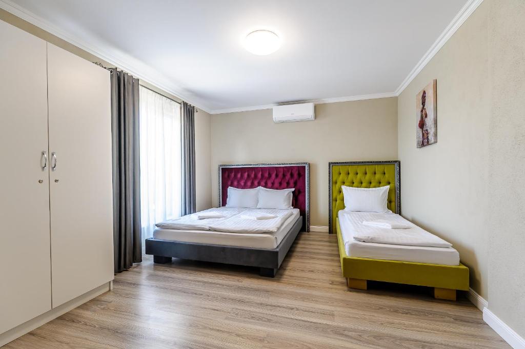 a room with two beds and a window at Villa Cristian in Arad