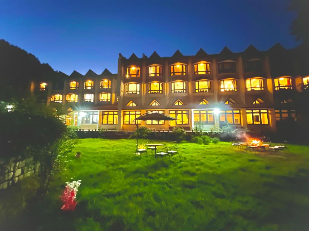 a large building with lights on at night at Sagar Heritage Resort, Manali in Manāli