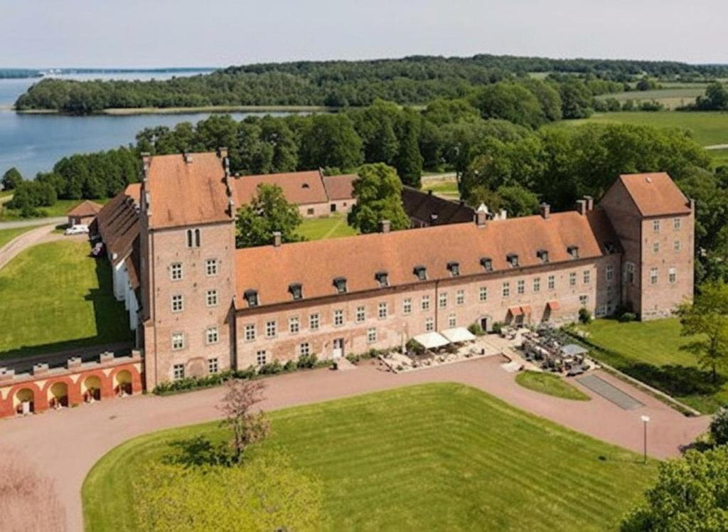 an aerial view of a large building with a large yard at 1-Bed Kristianstad Apartment - Sleeps 6 & Pets Ok in Fjälkinge