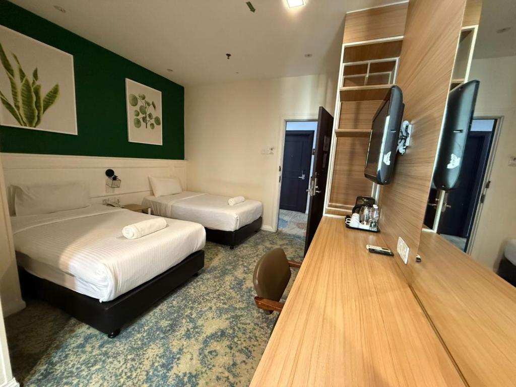 Ένα ή περισσότερα κρεβάτια σε δωμάτιο στο Asto Hotels Kuala Lumpur