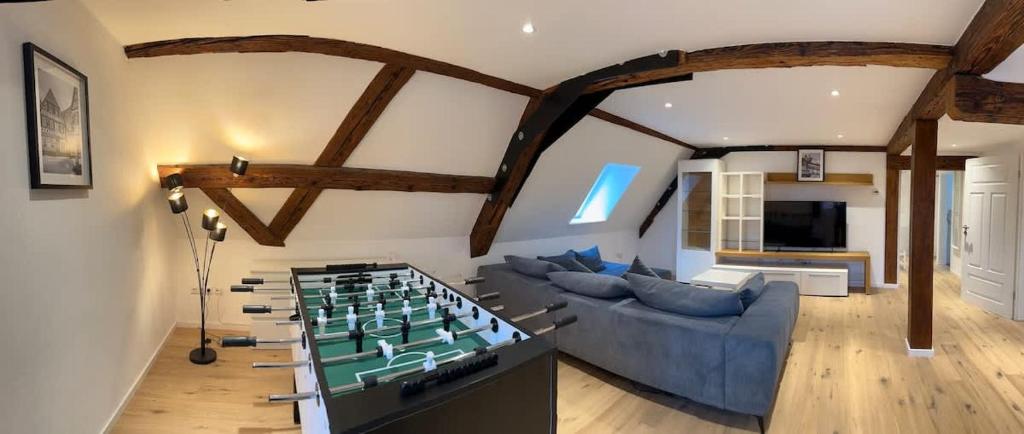 a living room with a large foosball table at Juraperle - Historisch und modern - Wohnung 2 in Bad Staffelstein