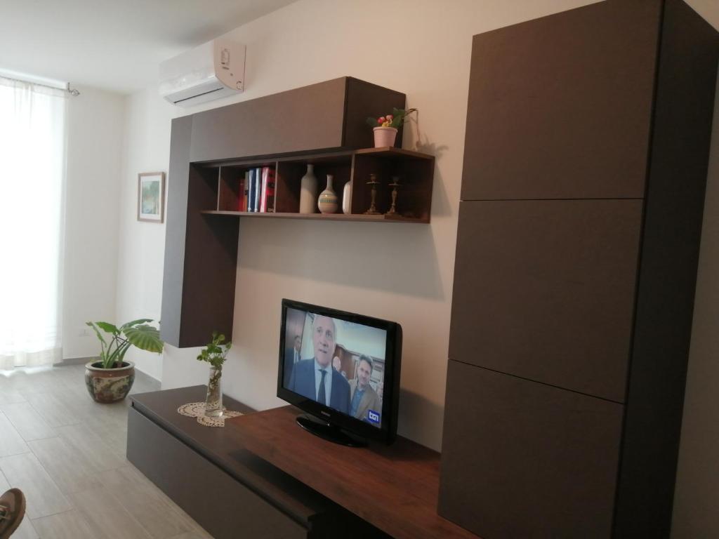 ein Wohnzimmer mit einem Flachbildfernseher auf einem Tisch in der Unterkunft Suite Petit in Vairano Scalo