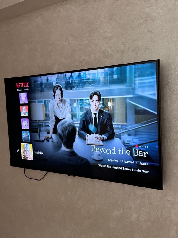 a flat screen tv hanging on a wall at Spacious Apartment in heart of Agadir in Agadir