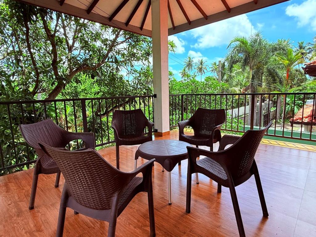 a group of chairs and a table on a porch at Transit villa 10 minutes drive from the Airport in Katunayake