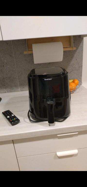 a black toaster sitting on top of a kitchen counter at Cozy Apartment in Kaunas with Free Parking in Kaunas
