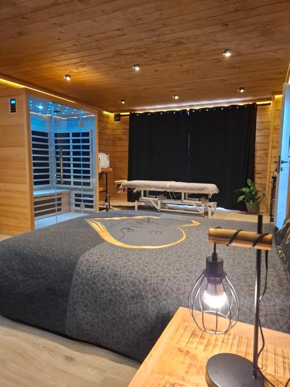 a bedroom with a bed and a stage at Chambre spa eden in Sainte-Ode