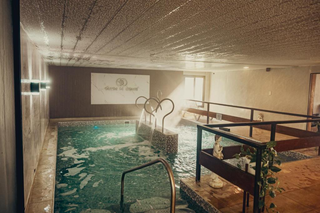 a swimming pool in a large room with a pool at Olivos de Monte in San Miguel del Monte