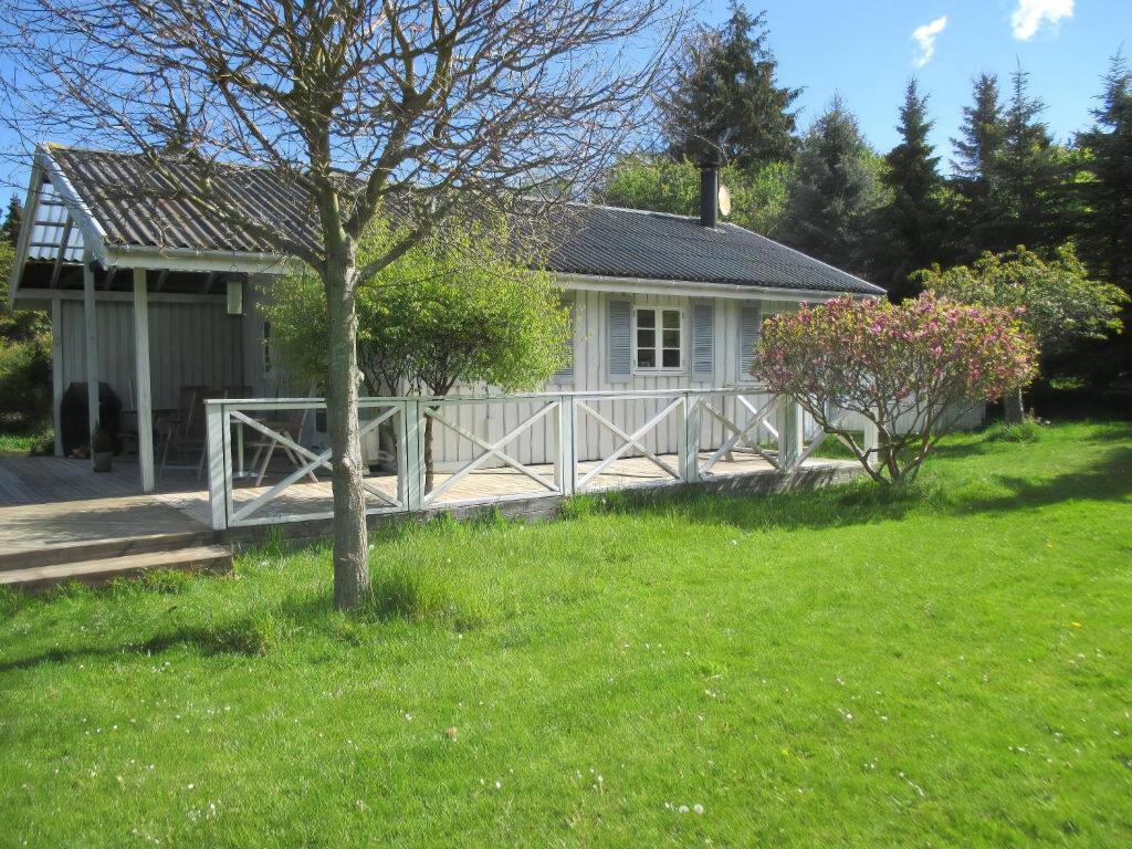 a house with a wooden fence in front of a yard at Stunning Home In Nykøbing Sjælland W in Nykøbing Sjælland
