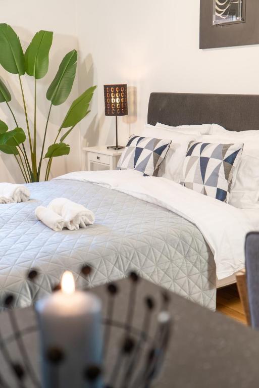 a bedroom with two beds and a table with a plant at Prime City Location, Spacious Studio Apartment in Gothenburg