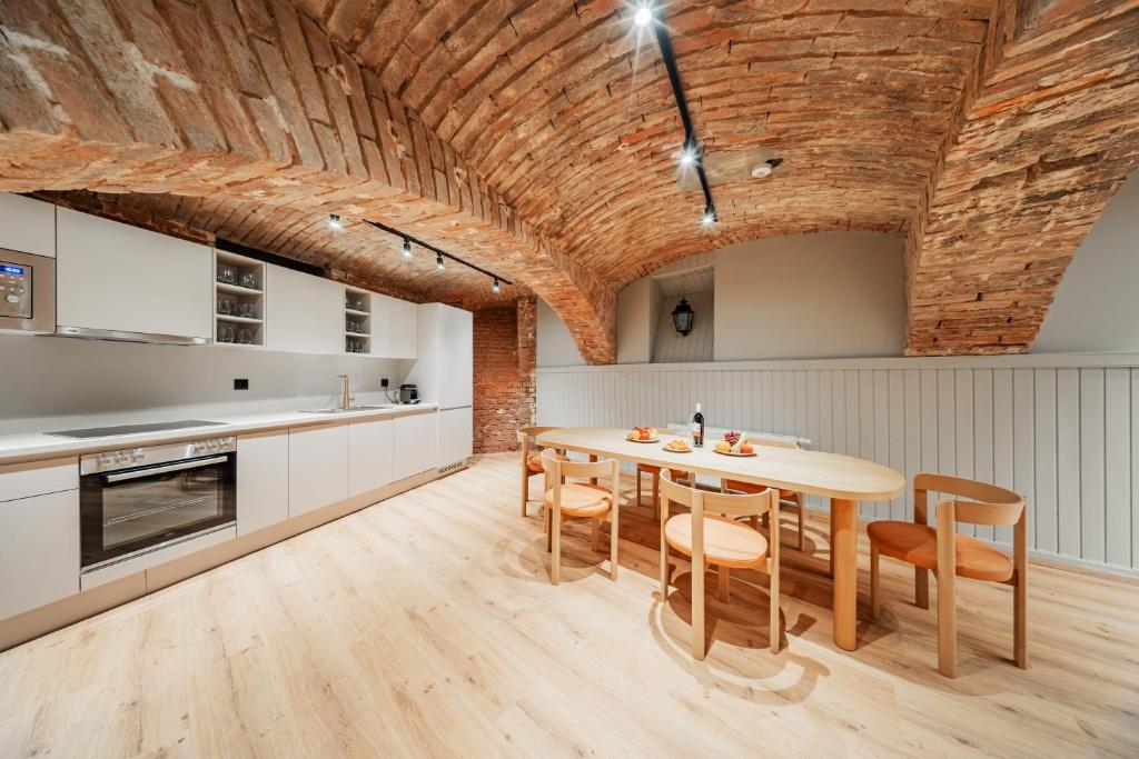 a kitchen with a dining room table and chairs at Hive 5 by HOME1 - District 8 Boutique Hostel in Vienna