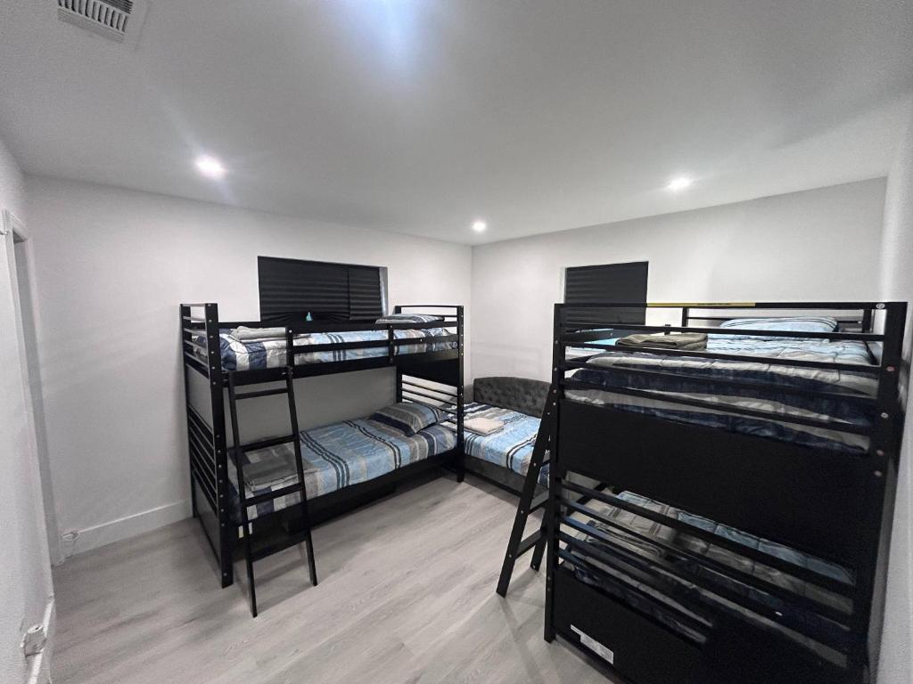 a room with three bunk beds in it at Place to stay in Hallandale Beach