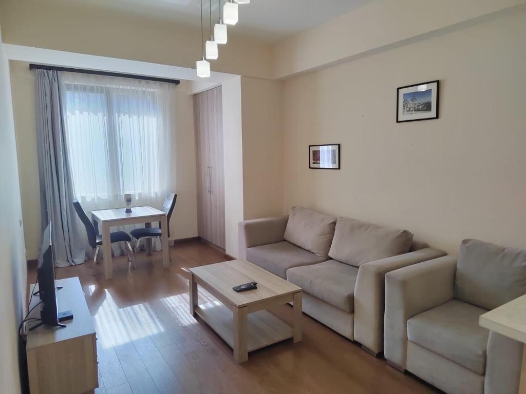 a living room with a couch and a table at Yerevan Hotel in Yerevan