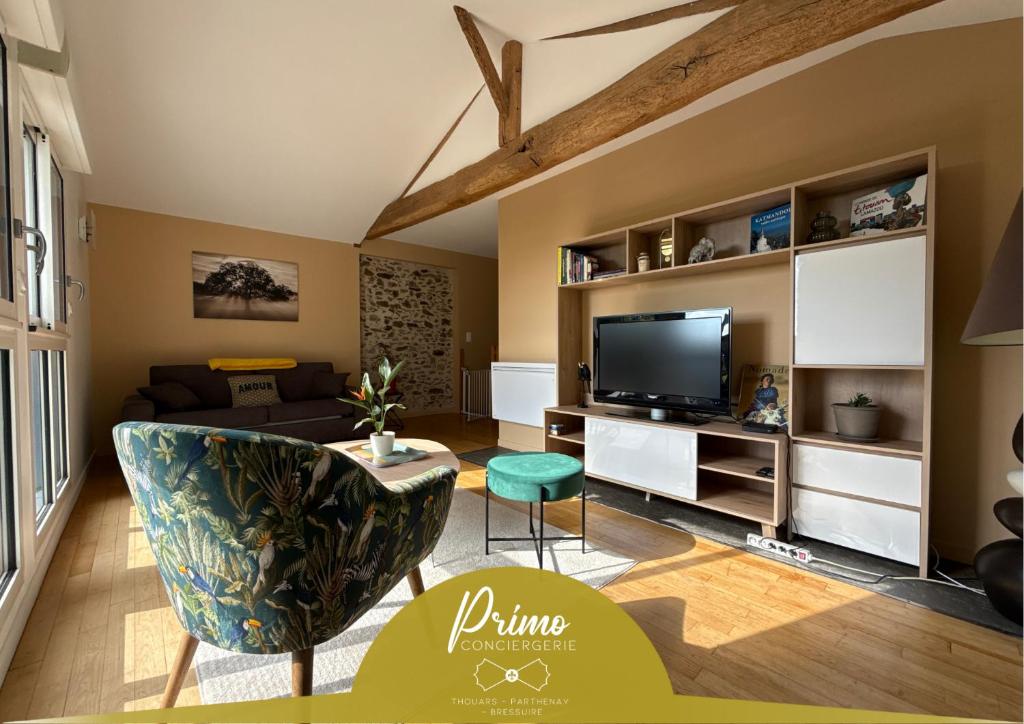 a living room with a couch and a tv at Le Verger - Gite 8 personnes en campagne et rivière By Primo in La Forêt-sur-Sèvre