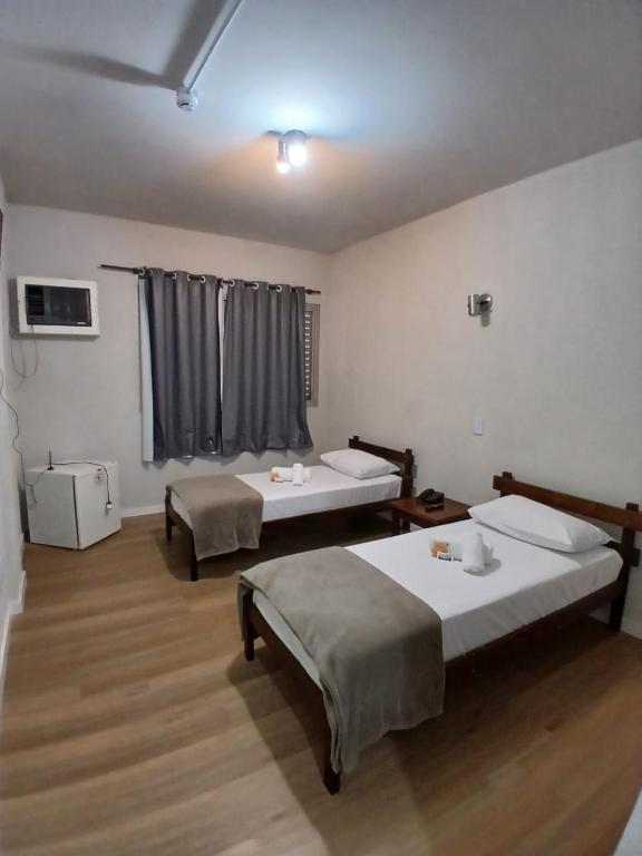a room with two beds and a window at Westin Palace Hotel in Mogi Mirim
