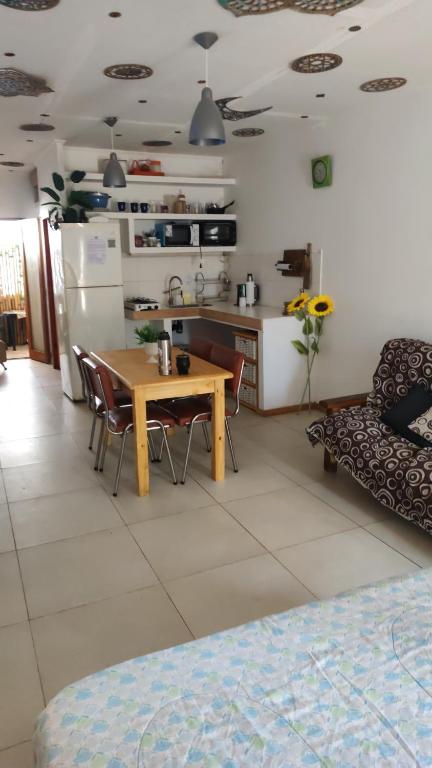 a kitchen and living room with a table and a refrigerator at Espacio R&P in Santa Clara del Mar