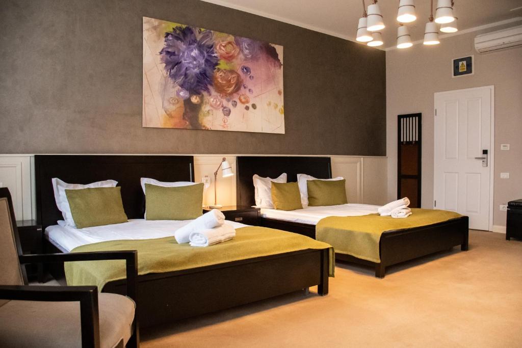 a room with two beds with towels on them at Hirscher 14 in Braşov