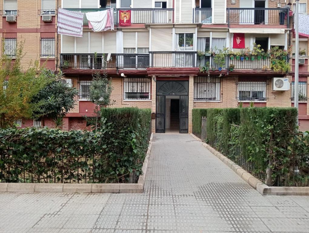 an apartment building with a walkway in front of it at Habitación Cama Literas Mixta Castilleja de la Cuesta in Castilleja de la Cuesta