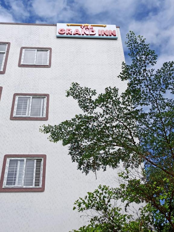 a sign on the side of a building at The Grand Inn - Kempegowda Airport Bangalore in Devanhalli