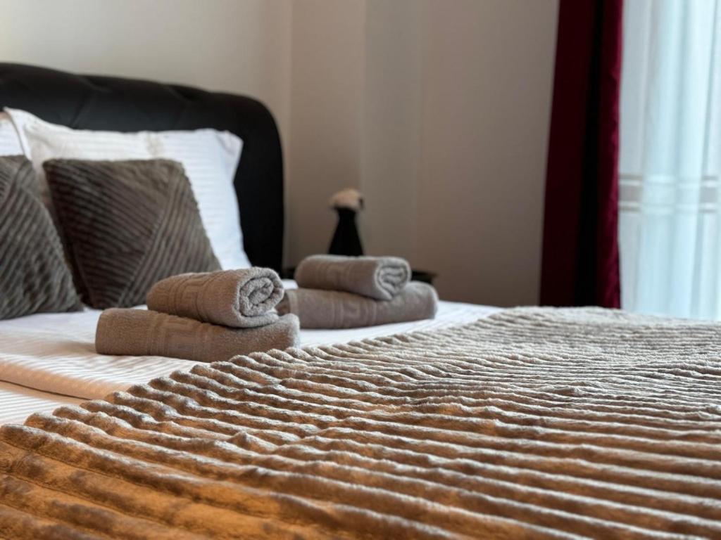 a bedroom with a bed with towels on it at 13StudioBv in Braşov