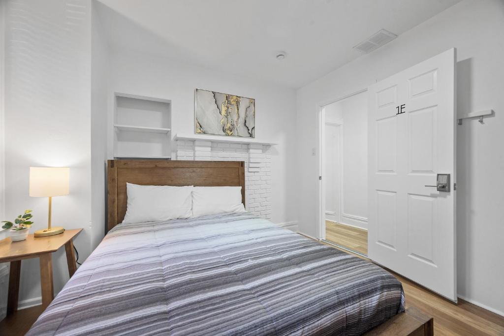 a bedroom with a bed and a white door at Pittsburgh Shadyside 1E Bright and Modern Private Bedroom with Shared Bathroom in Pittsburgh