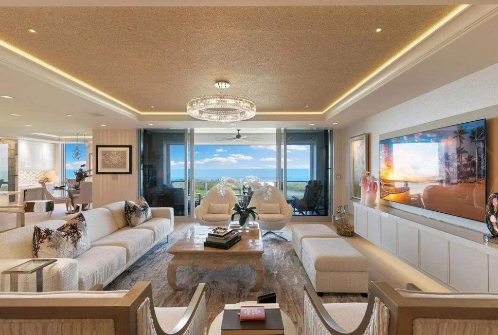 a living room with a couch and a table at Smart-home & Panoramic Water Views in Naples