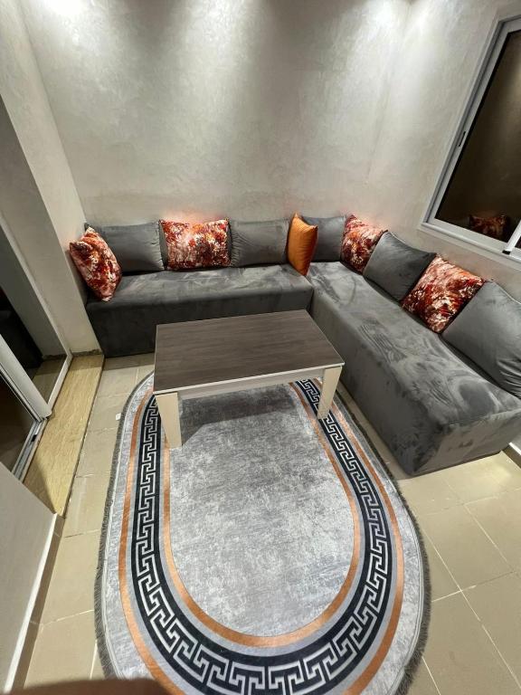 a living room with a couch and a coffee table at Studio Riviera in Tangier