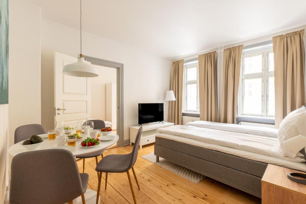 a large bedroom with a large bed and a table at Authentic Copenhagen Apartment for 4 Guests in Copenhagen