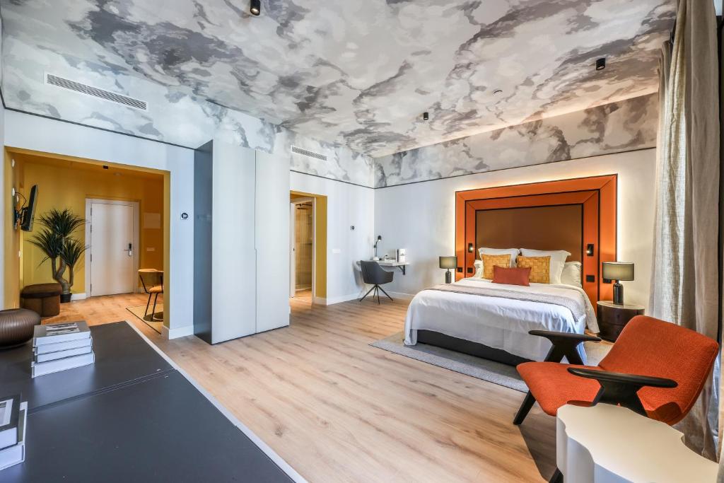 a bedroom with a bed and a ceiling with clouds at AmazINN Collection Madrid Plaza Mayor in Madrid